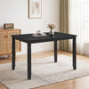 Rectangular black kitchen table with solid rubber wood legs, comfortably seating four, featuring elegant engraved leg detailing.