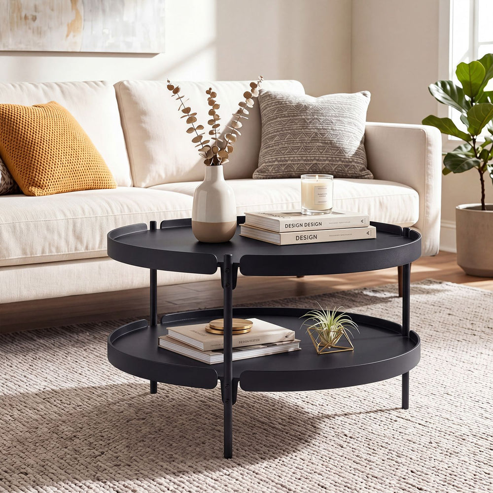 Round black 2-tier plastic coffee table with lower shelf for storage, perfect for modern living room decor.