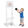 Young child shooting a basketball at the toddler sports set’s hoop, designed for active outdoor play and adjustable height.