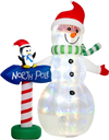 6 FT inflatable snowman with penguin and North Pole sign glows with colorful LED lights in a snowy holiday yard.