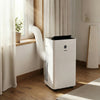 VEVOR portable air conditioner installed by a window in a room