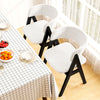 Mid-century modern dining chairs in white faux sherpa with black wood frames, perfect for stylish kitchen dining.
