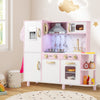 Pink wooden kitchen playset showcasing the range hood and stoves, featuring lights and sounds for creative play.